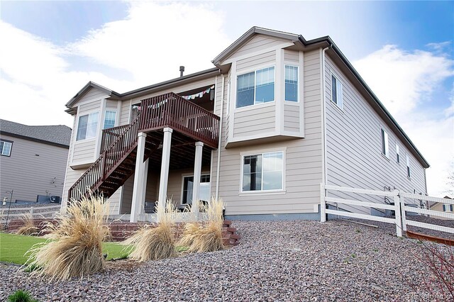 3910 Mighty Oaks St, Castle Rock, CO 80104 - rear view of property featuring a deck, fence, and stairs