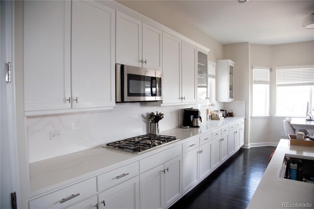 3910 Mighty Oaks St, Castle Rock, CO 80104 - kitchen featuring stainless steel appliances, white cabinetry, glass insert cabinets, and dark wood finished floors