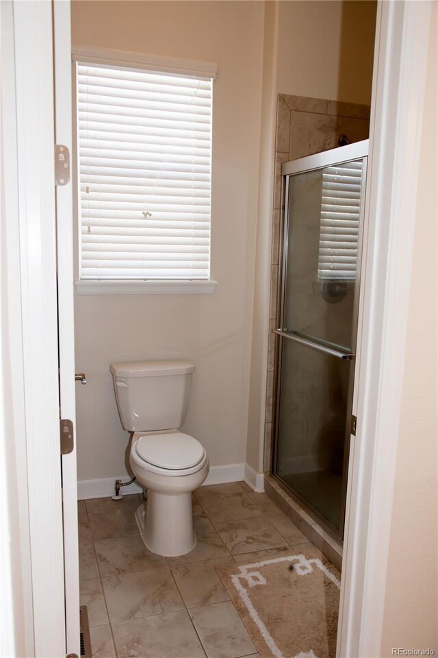 3910 Mighty Oaks St, Castle Rock, CO 80104 - full bathroom with a stall shower, baseboards, toilet, and marble finish flooring