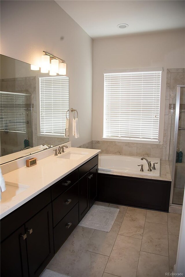 3910 Mighty Oaks St, Castle Rock, CO 80104 - bathroom featuring a stall shower, double vanity, and a bath