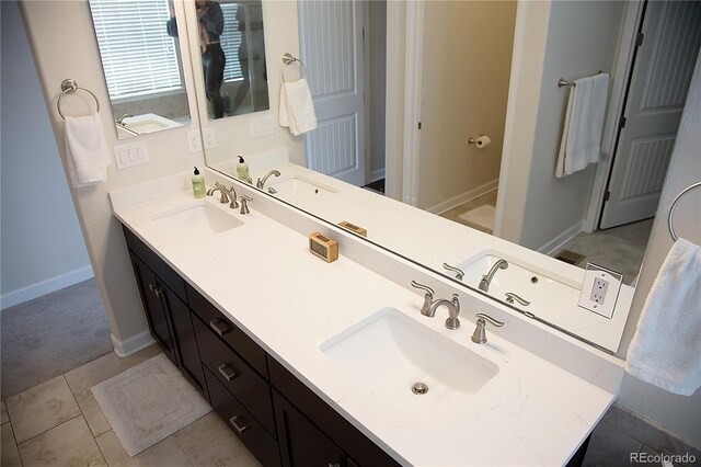 3910 Mighty Oaks St, Castle Rock, CO 80104 - bathroom featuring double vanity, baseboards, and tile patterned floors