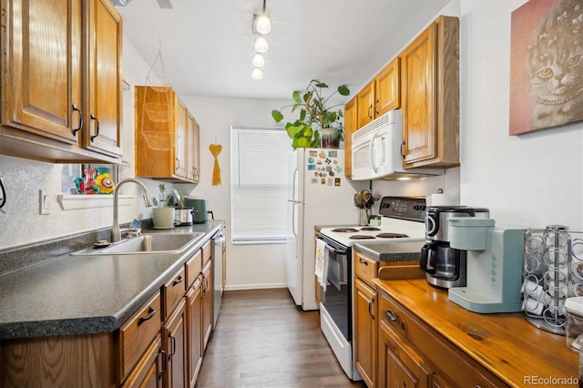 2277 S Buckley Rd Unit 102, Aurora, CO 80013 - kitchen featuring white appliances, a sink, and brown cabinets