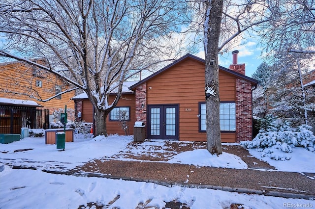 2277 S Buckley Rd Unit 102, Aurora, CO 80013 - view of front of home with french doors, a chimney, and brick siding