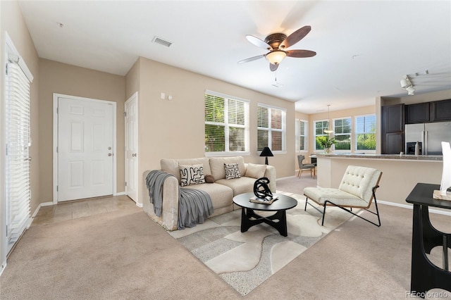 9637 E 5th Ave Unit 101, Denver, CO 80230 - living area with light colored carpet and a ceiling fan