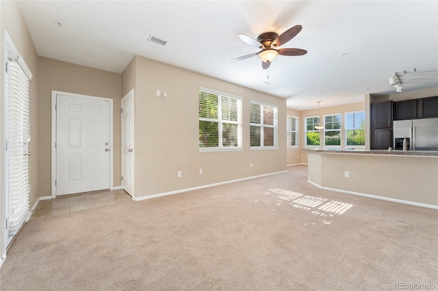 9637 E 5th Ave Unit 101, Denver, CO 80230 - unfurnished living room featuring ceiling fan and light carpet