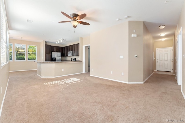 9637 E 5th Ave Unit 101, Denver, CO 80230 - unfurnished living room featuring light carpet and ceiling fan