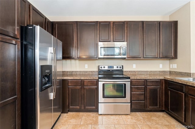 9637 E 5th Ave Unit 101, Denver, CO 80230 - kitchen featuring stainless steel appliances, dark brown cabinetry, and light tile patterned flooring