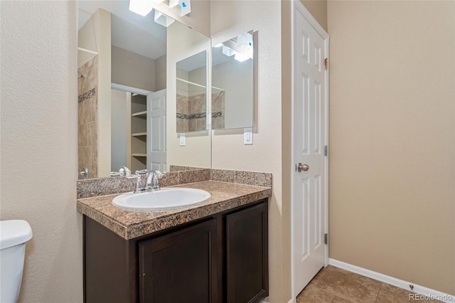 9637 E 5th Ave Unit 101, Denver, CO 80230 - bathroom with vanity, a tile shower, and tile patterned floors