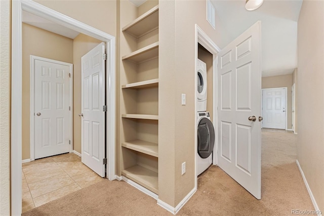 9637 E 5th Ave Unit 101, Denver, CO 80230 - laundry area featuring stacked washing machine and dryer, carpet floors, and built in features