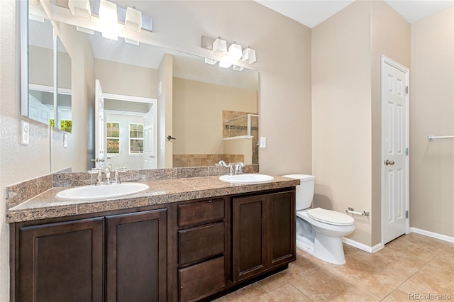 9637 E 5th Ave Unit 101, Denver, CO 80230 - bathroom featuring a tile shower, double vanity, and tile patterned floors