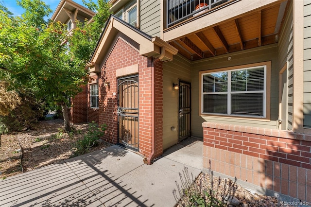 9637 E 5th Ave Unit 101, Denver, CO 80230 - property entrance with brick siding, a gate, and a patio area