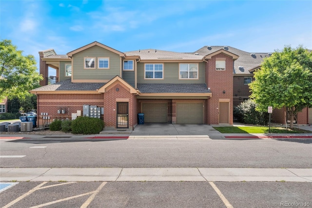 9637 E 5th Ave Unit 101, Denver, CO 80230 - multi unit property with an attached garage, brick siding, and roof with shingles