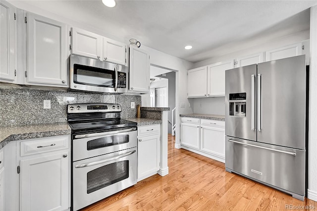 kitchen with tasteful backsplash, recessed lighting, stainless steel appliances, light wood-style floors, and white cabinetry