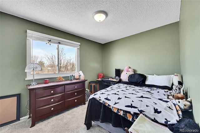 bedroom featuring light colored carpet and a textured ceiling