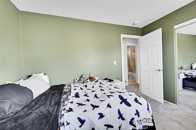 bedroom with a textured ceiling and carpet