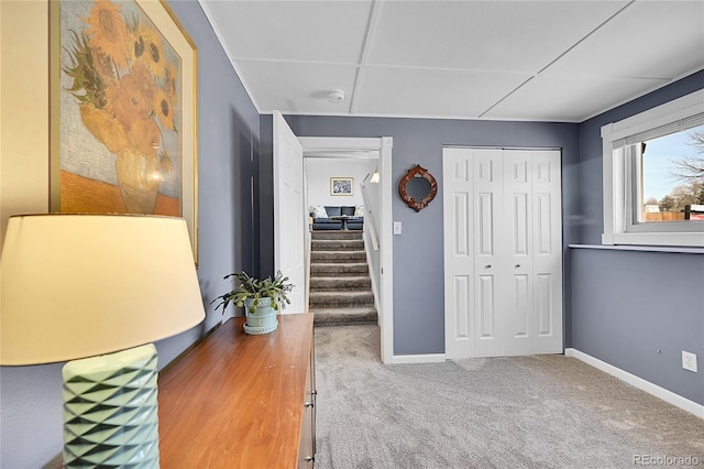 interior space with stairway, baseboards, and carpet floors