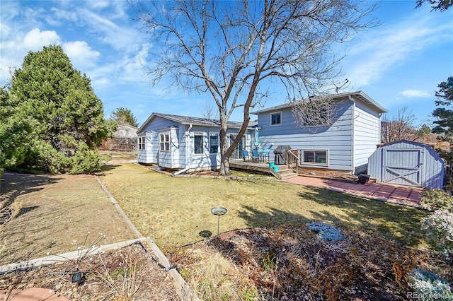 rear view of property featuring a deck, a storage shed, an outdoor structure, and a lawn