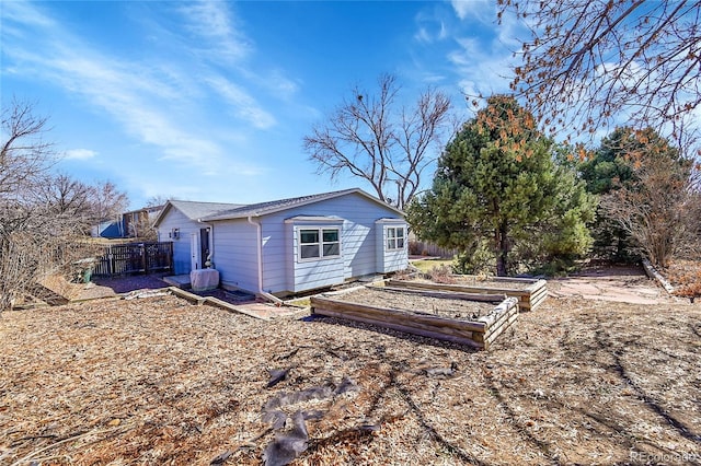 rear view of house with fence