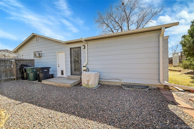 back of house with fence