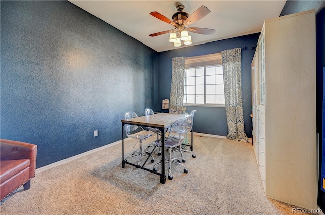 office space with baseboards, ceiling fan, carpet, and a textured wall