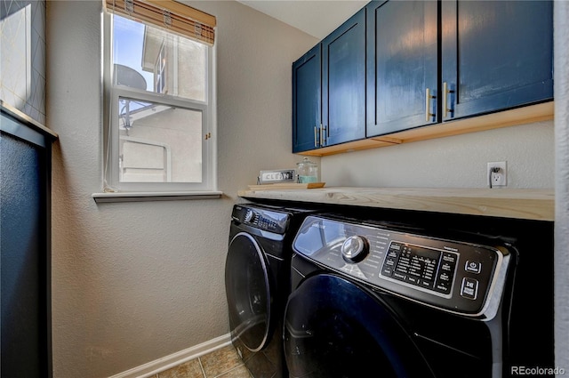 laundry room featuring washer and dryer, baseboards, and cabinet space