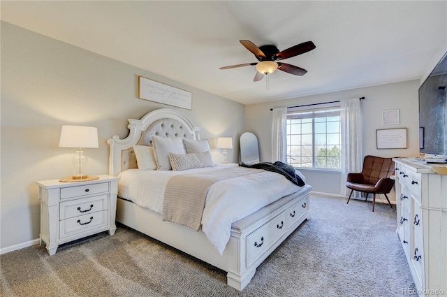 bedroom featuring baseboards, a ceiling fan, and light colored carpet