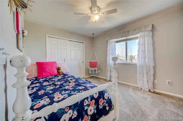 bedroom featuring a closet, carpet flooring, baseboards, and a ceiling fan