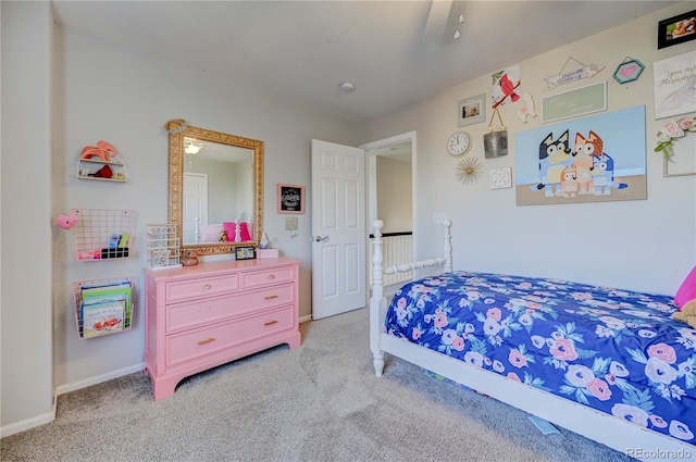 carpeted bedroom featuring baseboards and a ceiling fan