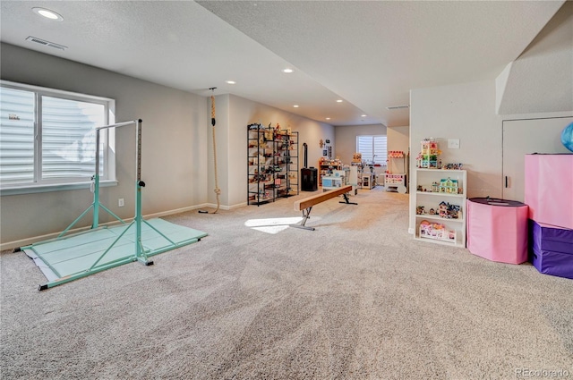 playroom with baseboards, recessed lighting, carpet flooring, a textured ceiling, and visible vents