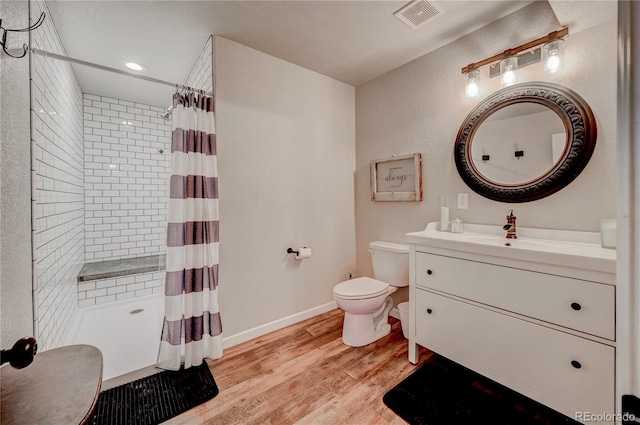 full bath with visible vents, toilet, a shower with curtain, and wood finished floors