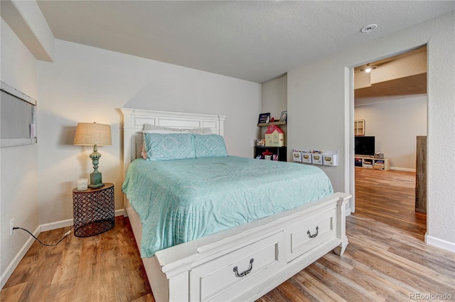 bedroom with baseboards and light wood-style floors