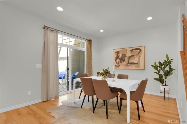 dining space with light wood-style floors, baseboards, and recessed lighting