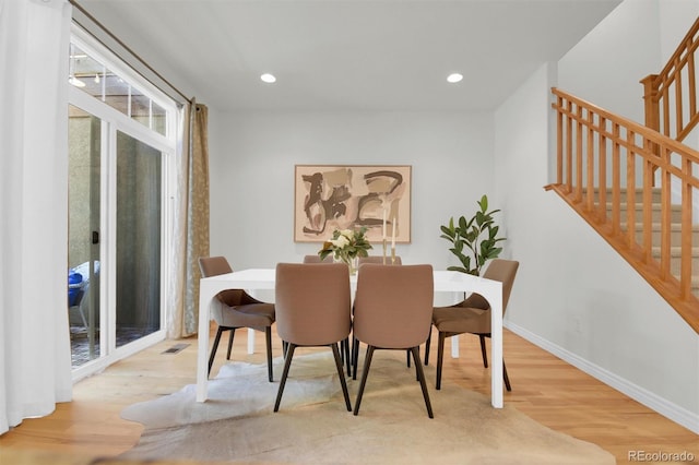 dining area featuring wood finished floors, stairs, baseboards, and recessed lighting