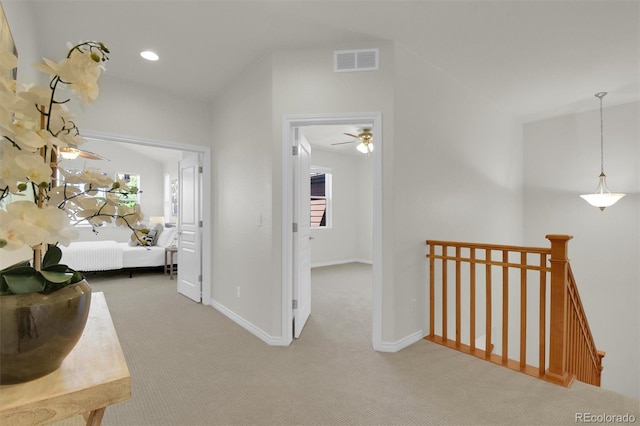 corridor featuring an upstairs landing, carpet, and baseboards