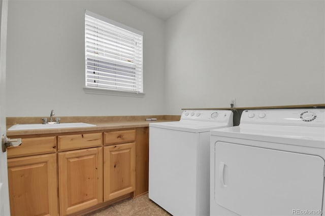 clothes washing area featuring washing machine and clothes dryer and cabinet space