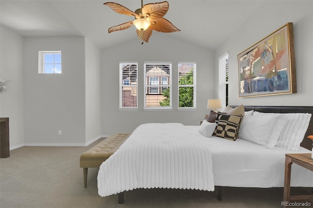 carpeted bedroom featuring vaulted ceiling, baseboards, and a ceiling fan