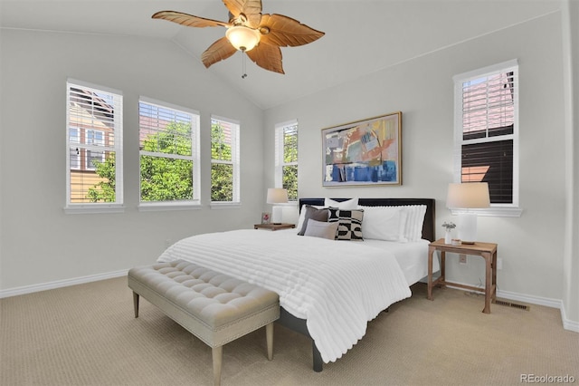 bedroom with carpet, baseboards, vaulted ceiling, and a ceiling fan