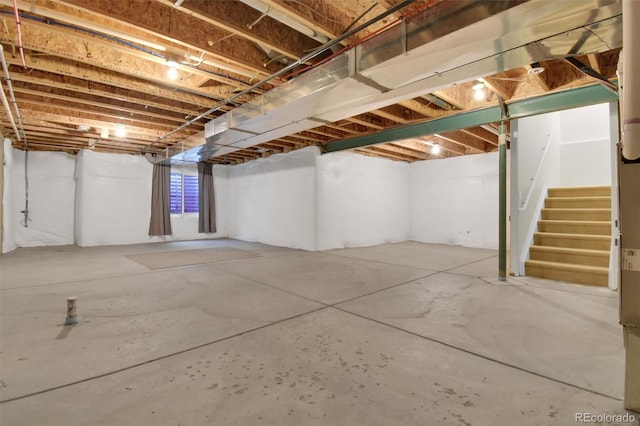 unfinished basement featuring stairs