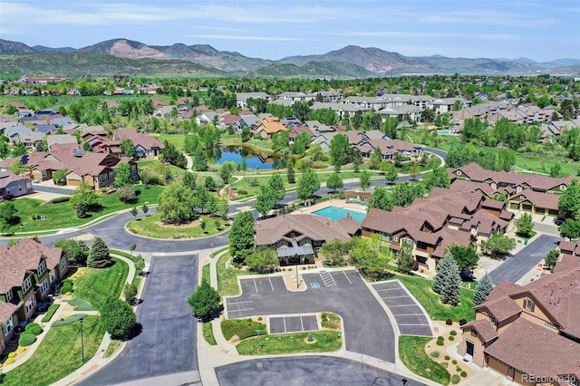 aerial view of property's location with nearby suburban area and a water and mountain view