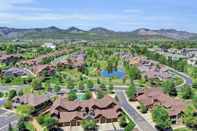 view of property location featuring nearby suburban area and a water and mountain view