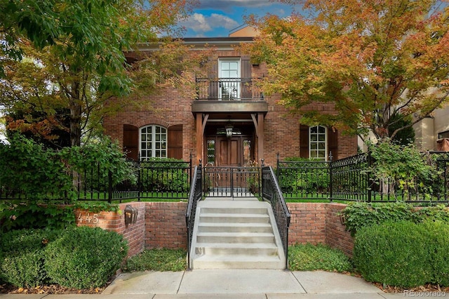 445 Madison St N, Denver, CO 80206 - view of front of property with a balcony, fence, and brick siding