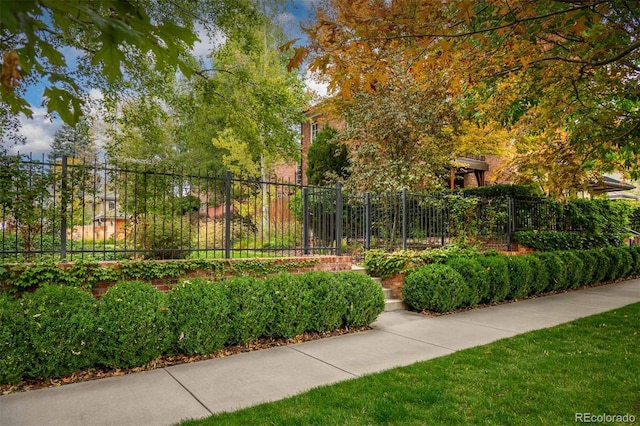 view of home's community featuring fence