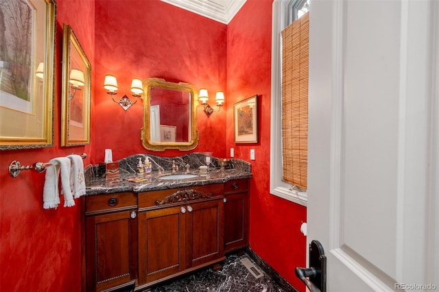 bathroom featuring ornamental molding, vanity, and baseboards