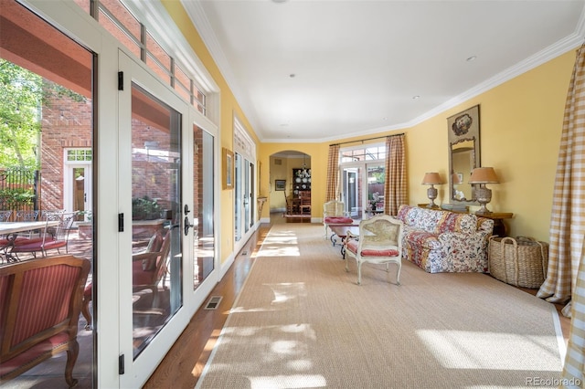 sunroom / solarium featuring visible vents, arched walkways, and french doors