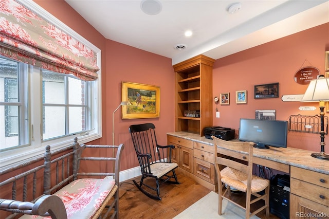 office area with baseboards, visible vents, and light wood-style floors