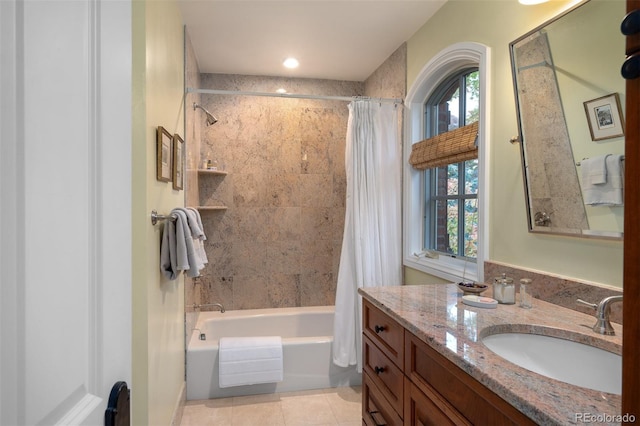 bathroom with tile patterned floors, shower / bathtub combination with curtain, and vanity