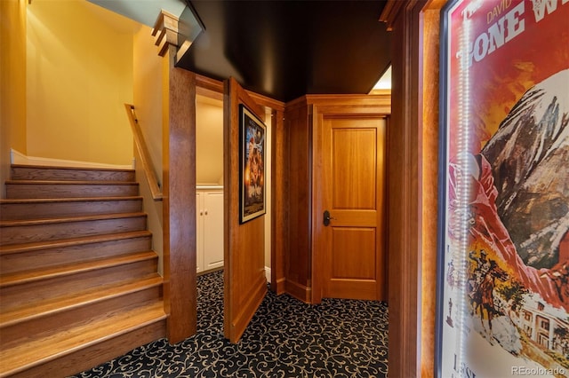 hallway featuring stairs and carpet flooring