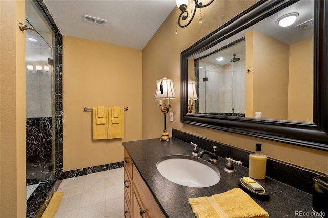 full bathroom with a shower stall, visible vents, baseboards, and vanity