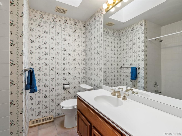 bathroom with a skylight, visible vents, toilet, and tile patterned floors