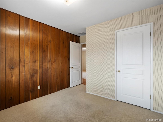 unfurnished bedroom featuring carpet floors, a closet, and visible vents